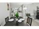 The dining room features a table set for four and offers a view into the kitchen at 4741 Watkins Ave, Sarasota, FL 34233