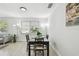 Bright dining area with a table set for four, complemented by natural light and modern flooring at 4741 Watkins Ave, Sarasota, FL 34233
