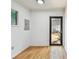 Bright entryway featuring hardwood floors, fresh white walls and natural light from a window and door at 4741 Watkins Ave, Sarasota, FL 34233