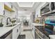 Bright kitchen featuring white cabinets, a stainless steel stove, and subway tile backsplash, for stylish meal preparation at 4741 Watkins Ave, Sarasota, FL 34233