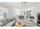 Bright living room featuring modern decor, wood-look flooring, and an open layout to dining area at 4741 Watkins Ave, Sarasota, FL 34233