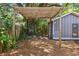 Backyard view showcasing a rustic pergola with natural surroundings at 4741 Watkins Ave, Sarasota, FL 34233