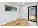 Bright room featuring hardwood floors, fresh white walls and natural light from a window and door at 4741 Watkins Ave, Sarasota, FL 34233