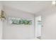 Bright room with white walls, a window view of lush foliage, and doorway leading to another space at 4741 Watkins Ave, Sarasota, FL 34233