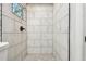 Shower stall featuring white marble tile and contemporary bronze fixtures at 4741 Watkins Ave, Sarasota, FL 34233