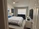 Comfortable bedroom with a queen size bed, soothing color palette, and a large window for natural light at 4907 Kilty E Ct, Bradenton, FL 34203