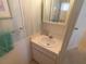 Small bathroom featuring a white sink and vanity with blue accents at 4920 Boca Raton Ave, Sarasota, FL 34234