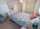 Inviting bedroom with floral bedding, dresser, and cozy seating area at 4920 Boca Raton Ave, Sarasota, FL 34234