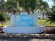 Welcome to Tri-Par Estates! View of community sign with water feature and lush landscaping at 4920 Boca Raton Ave, Sarasota, FL 34234