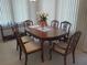 Elegant dining area with a wooden table, six chairs, and stylish decor at 4920 Boca Raton Ave, Sarasota, FL 34234