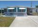 Charming home featuring awnings and a carport with a sun decoration at 4920 Boca Raton Ave, Sarasota, FL 34234
