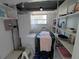 Storage area with shelving and a utility sink with natural light at 4920 Boca Raton Ave, Sarasota, FL 34234