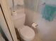 Small bathroom featuring a white toilet and roll holder, with blue accents at 4920 Boca Raton Ave, Sarasota, FL 34234