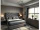 This main bedroom features a large bed with a tufted headboard, stylish decor, and plenty of natural light from the window at 4970 Oyster Pearl St, Lakewood Ranch, FL 34211