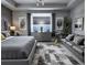Serene gray bedroom with a king-size bed, seating area, and a view of the ocean at 4970 Oyster Pearl St, Lakewood Ranch, FL 34211