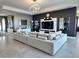 Modern living room with a large white couch, stylish decor, and contemporary lighting at 4970 Oyster Pearl St, Lakewood Ranch, FL 34211