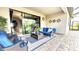 Outdoor patio space with comfortable seating, a coffee table, and a view into a living area through sliding glass doors at 4970 Oyster Pearl St, Lakewood Ranch, FL 34211