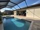 Screened-in pool and spa area with covered patio in a private backyard at 4970 Oyster Pearl St, Lakewood Ranch, FL 34211