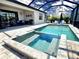 Inviting screened pool area features a spa, sun loungers, and outdoor seating for luxurious outdoor living at 4970 Oyster Pearl St, Lakewood Ranch, FL 34211