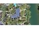 Aerial view of a home surrounded by lush trees, offering water access and a private, serene setting at 5033 Oxford Dr, Sarasota, FL 34242