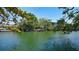 A view of a lush backyard with access to a serene canal at 5033 Oxford Dr, Sarasota, FL 34242