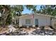 Exterior view of a single Gathering home with lots of mature trees at 5033 Oxford Dr, Sarasota, FL 34242
