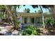 Enclosed sunroom featuring walls of glass and views of the mature landscaping surrounding the home at 5033 Oxford Dr, Sarasota, FL 34242