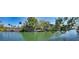 Beautiful waterfront property with lush trees and a glimpse of the home, offering a serene and picturesque setting at 5033 Oxford Dr, Sarasota, FL 34242