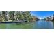 Expansive waterfront view highlighting the canal, lush landscaping, and multiple docks for boating convenience at 5033 Oxford Dr, Sarasota, FL 34242