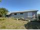 The back exterior of a single Gathering home with an awning over the back porch at 5315 Malamin Rd, North Port, FL 34287