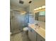 Modern bathroom features a glass-enclosed shower with tile surround, vanity with sink, and contemporary lighting at 5315 Malamin Rd, North Port, FL 34287
