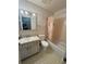 Cozy bathroom features a vanity with marble countertop, toilet and shower/tub combo with a patterned shower curtain at 5315 Malamin Rd, North Port, FL 34287