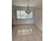 Bright dining room with tile floors and a large window. Features a chandelier above at 5315 Malamin Rd, North Port, FL 34287