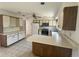 Efficient kitchen layout with tiled floors, updated appliances, and plenty of cabinet space at 5315 Malamin Rd, North Port, FL 34287