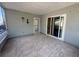 Tiled patio with sliding glass doors and screened windows, offering a versatile space for relaxation and entertaining at 5315 Malamin Rd, North Port, FL 34287