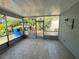Enclosed patio with screened windows and tile flooring providing a relaxing outdoor space with views of the garden at 5315 Malamin Rd, North Port, FL 34287