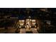 Night aerial view of the modern home with illuminated windows and balconies, surrounded by lush landscaping at 540 S Polk Dr, Sarasota, FL 34236