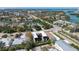 Stunning aerial view of modern home with rooftop deck, lush landscaping, and waterfront access in a desirable neighborhood at 540 S Polk Dr, Sarasota, FL 34236