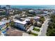 Aerial view of a coastal home near the beach and open water, featuring a rooftop deck and modern architectural design at 540 S Polk Dr, Sarasota, FL 34236
