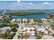 Expansive aerial view showcasing the home's proximity to the water, other residences, and surrounding tropical landscape at 540 S Polk Dr, Sarasota, FL 34236