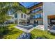 Backyard featuring an artificial lawn, pool, outdoor entertainment area, and lounge chairs at 540 S Polk Dr, Sarasota, FL 34236