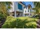 This backyard features an artificial lawn, putting green, and an outdoor entertainment area with a pool and lounge chairs at 540 S Polk Dr, Sarasota, FL 34236