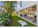 Backyard featuring an outdoor living space, artificial lawn, and cornhole game at 540 S Polk Dr, Sarasota, FL 34236
