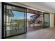 View from inside the home, to a terrace featuring an outdoor staircase and seating with neighborhood scenery at 540 S Polk Dr, Sarasota, FL 34236
