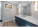 Modern bathroom featuring a blue vanity, white countertop, and a glass-enclosed shower with marble tile at 540 S Polk Dr, Sarasota, FL 34236