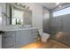 Modern bathroom featuring a sleek vanity, glass-enclosed shower, and neutral tones with light colored wood flooring at 540 S Polk Dr, Sarasota, FL 34236