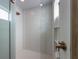 Modern glass shower with rain shower head and textured tile at 540 S Polk Dr, Sarasota, FL 34236