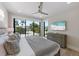 Bright bedroom with large windows offering a view and light, ceiling fan and a neutral color scheme at 540 S Polk Dr, Sarasota, FL 34236