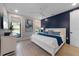 Comfortable bedroom with a blue accent wall, a white bed and a light-filled room at 540 S Polk Dr, Sarasota, FL 34236