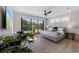 Stylish bedroom featuring a large window with a view, a ceiling fan and a sliding glass door at 540 S Polk Dr, Sarasota, FL 34236